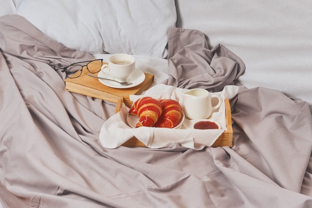 breakfast-bed-coffee-book-croissants-with-jam_271580-116